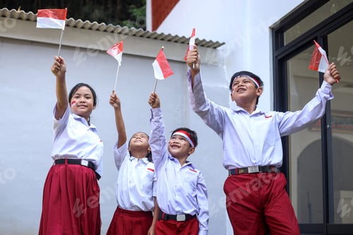 Preview: Children Celebrating with Flags Outside Building on Sunny Day