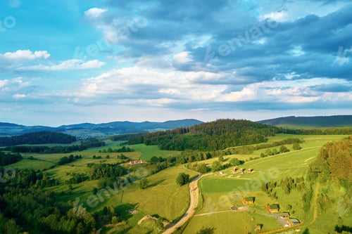 Preview: Aerial view of countryside area with village and mountains