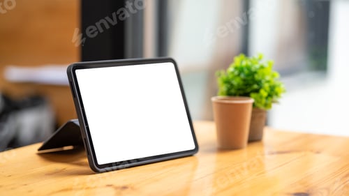 Preview: Tablet blank screen on desk and workspace background in modern office.