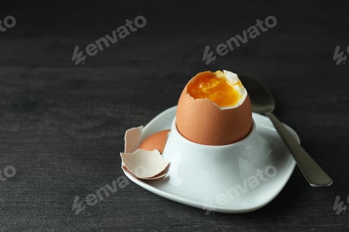 Preview: Concept of tasty breakfast with boiled egg on dark wooden table