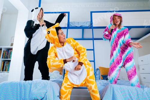 Preview: Multiethnic group of young female friends having pajamas party at home
