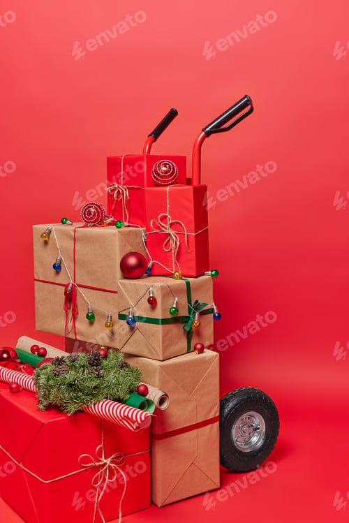 Preview: Vertical shot of track full of festive wrapped boxes and items for decoration isolated over bright
