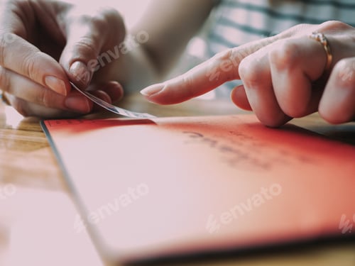 Preview: Woman Applying a Stamp to an Envelope