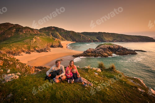 Preview: Portrait of family sitting on hillside, Murder hole beach, Melmor Head, Ireland