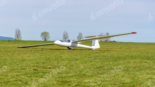 Preview: White glider on the grass airfield