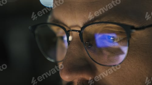 Preview: Close up male eyes in glasses eye strain problem medicine night dark man businessman developer