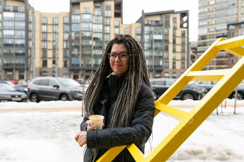 Preview: Photo on the street, young pretty informal woman wears dreadlocks hairstyle