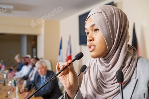 Preview: Pretty young Muslim woman in hijab speaking in microphone