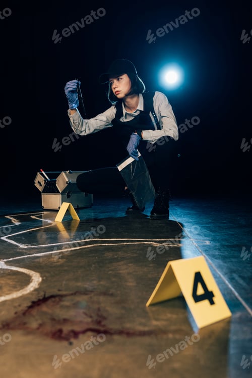 Preview: investigator holding knife and ziploc bag at crime scene