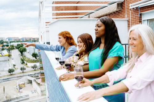 Preview: Group of Friends Enjoying a Festive Home Gathering with Wine and Food