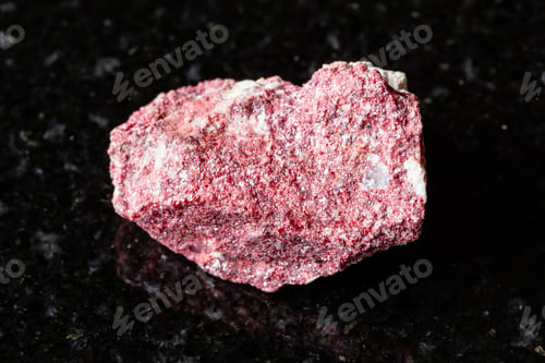 Preview: sample of rough cinnabar rock on black granite