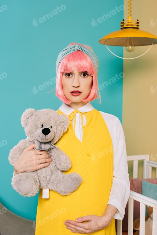 Preview: portrait of retro styled pregnant pin up woman with pink hair holding teddy bear in child room