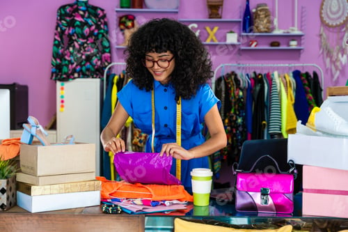 Preview: Beautiful young hispanic woman managing her home e-commerce business from home