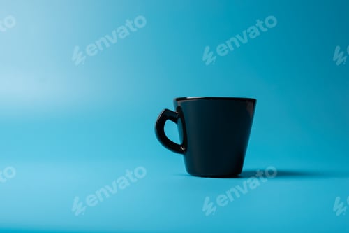 Preview: A black cup on a blue background. Minimalism