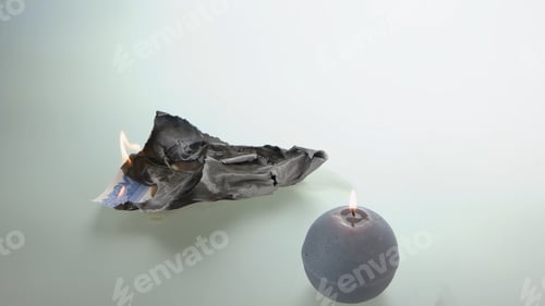 Preview: Burnt certificate and light candle.