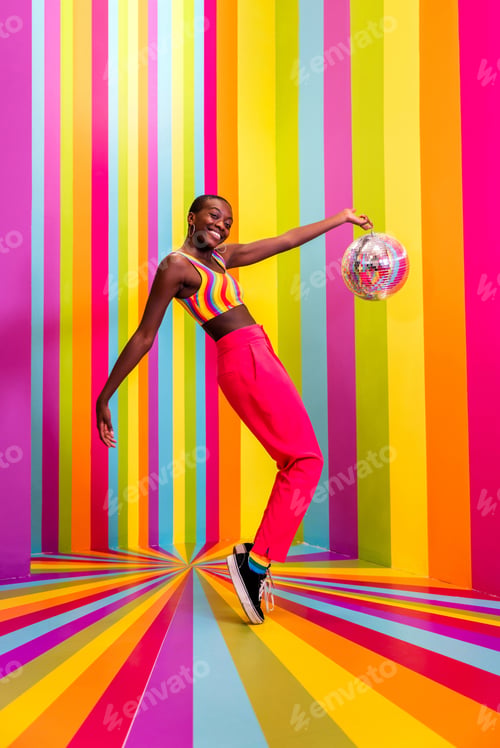Preview: Beautiful young woman dancing and having fun inside a rainbow box room