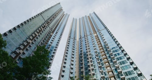 Preview: Low angle of the business building tower with white cloud pass though