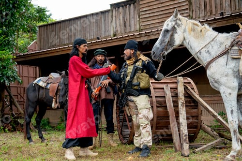 Preview: Wide shot group of men with soldier and arab clothes stand with holding hand