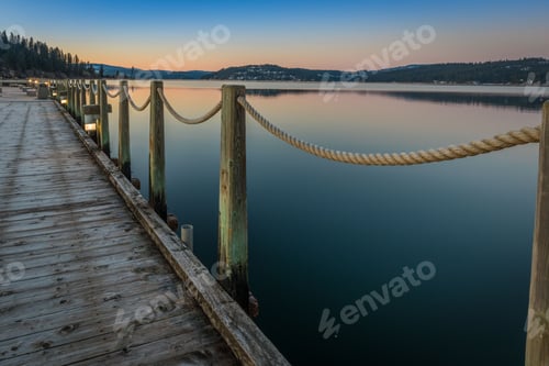 Preview: Scenic view of a wooden dock with a beautiful sunset in the background in Coeur d'Alene