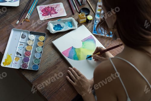 Preview: Woman Painting with Watercolor Paints at Wooden Table