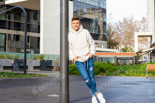 Preview: Young Man Leaning Against Pole In Urban Setting