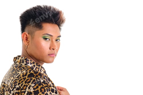 Preview: non-binary young asian person wearing leopard print shirt looking at camera on white background