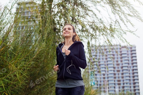 Preview: Young woman running in urban enviroment
