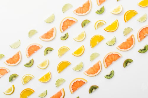 Preview: Flat lay with juicy cut fruits on white surface