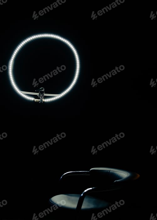 Preview: circular lamp and chair on black background minimalism