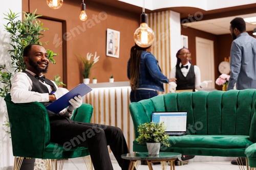 Preview: Friendly smiling hotel porter in lobby