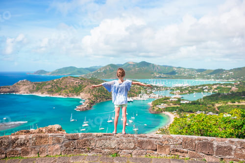 Preview: Little adorable kid with beautiful famous view. View of English Harbor from Shirley Heights, Antigua