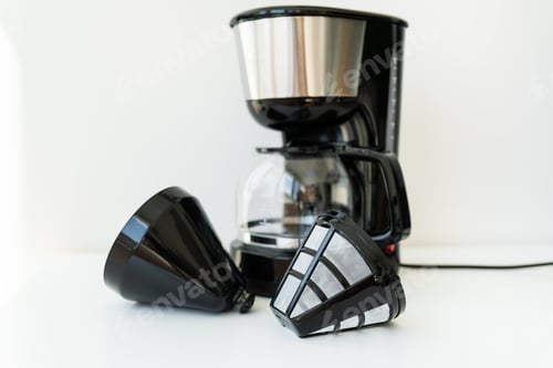 Preview: Automatic drip coffee maker isolated on white table. Black modern drip coffee pot.