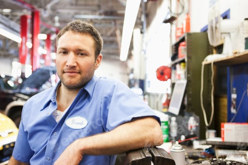 Preview: Portrait of a smiling Caucasian male mechanic in an auto repair shop