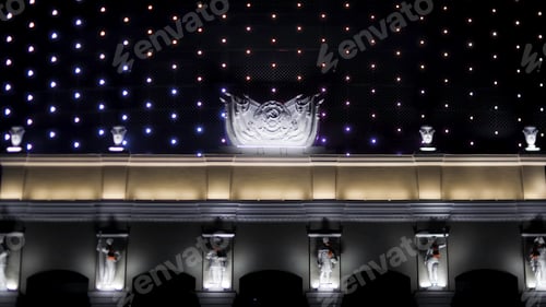 Preview: Bright illuminated facade of the soviet building at night with the Hammer and Sickle symbol. Stock