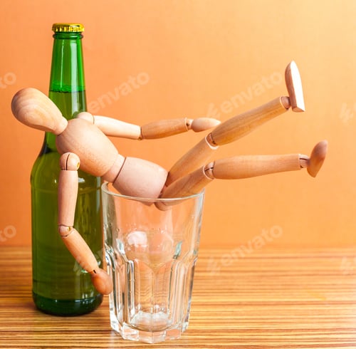 Preview: Alcoholism concept. Wooden doll with Alcohol drink