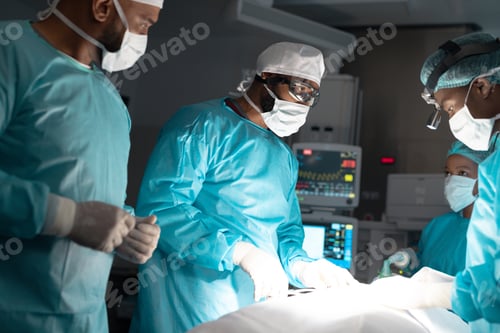 Preview: Diverse surgeons wearing surgical gowns operating on patient in operating theatre at hospital