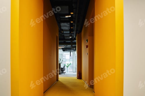 Preview: long corridor with walls painted in vibrant orange color in contemporary coworking office