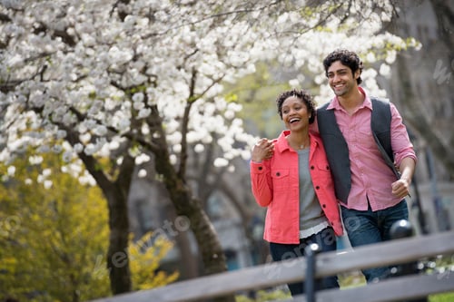 Preview: People outdoors in the city in spring time. New York City park. A man and woman side by side.