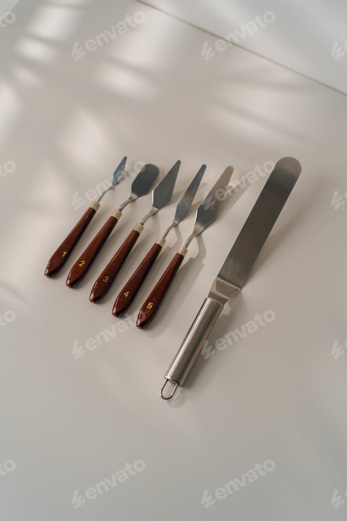 Preview: different types of pastry spatulas cooking utensils for cakes on the table on white background
