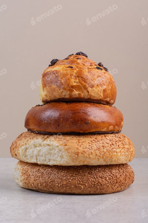 Preview: Stack of buns and bagels on gray background