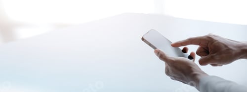Preview: Business man looking at financial information from a mobile phone.