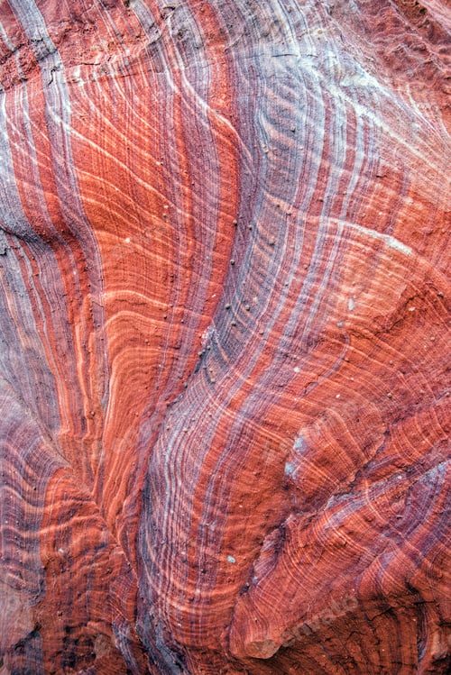 Preview: Colorful, red sandstone formation texture. Abstract geological pattern. Petra, Jordan