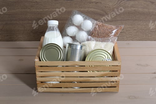 Preview: Donation box with food products on wooden table