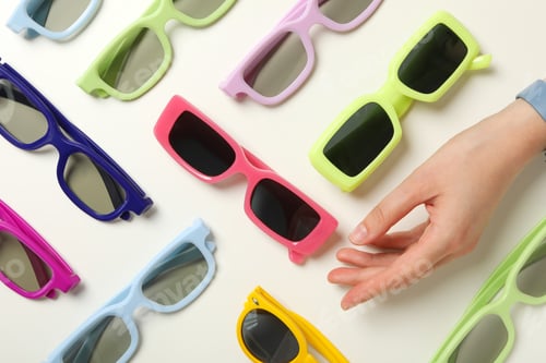 Preview: A pile of sunglasses, with a hand on a white background