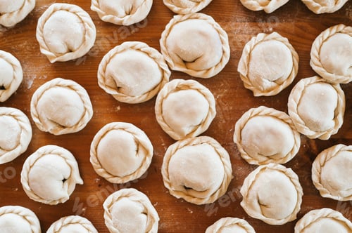 Preview: pile of homemade food dumplings on kitchen table. national traditional Russian cuisine. diy