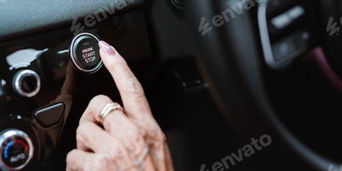 Preview: Close-up of a hand pressing a car's engine start button
