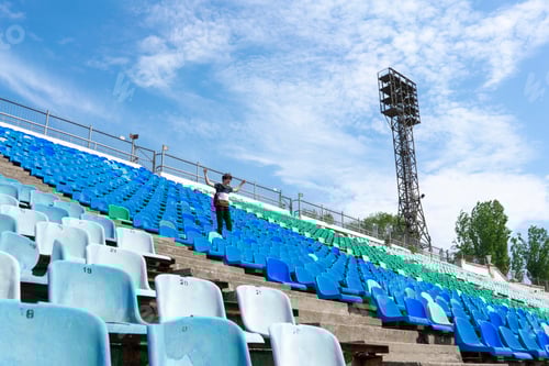 Preview: panorama of huge stadium seats with a man watching the music event concerts