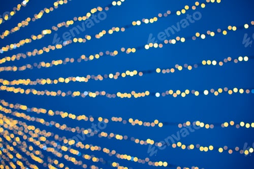 Preview: Yellow and blue abstract background of bokeh defocused blurred lights garland
