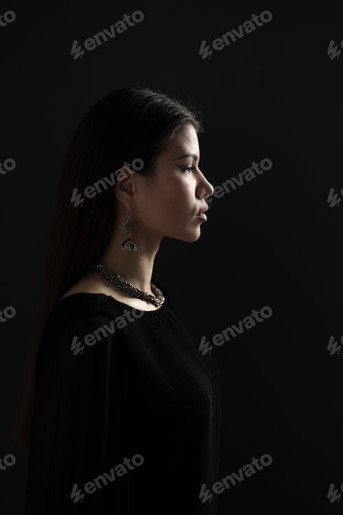 Preview: Elegant Woman in Profile Wearing Silver Jewelry