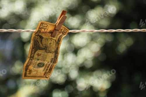 Preview: Ten Dollar Bill Hanging on Clothesline with Clothespin